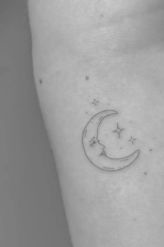 Moon face with stars tattoo in delicate fine line style by Chelsea.Q